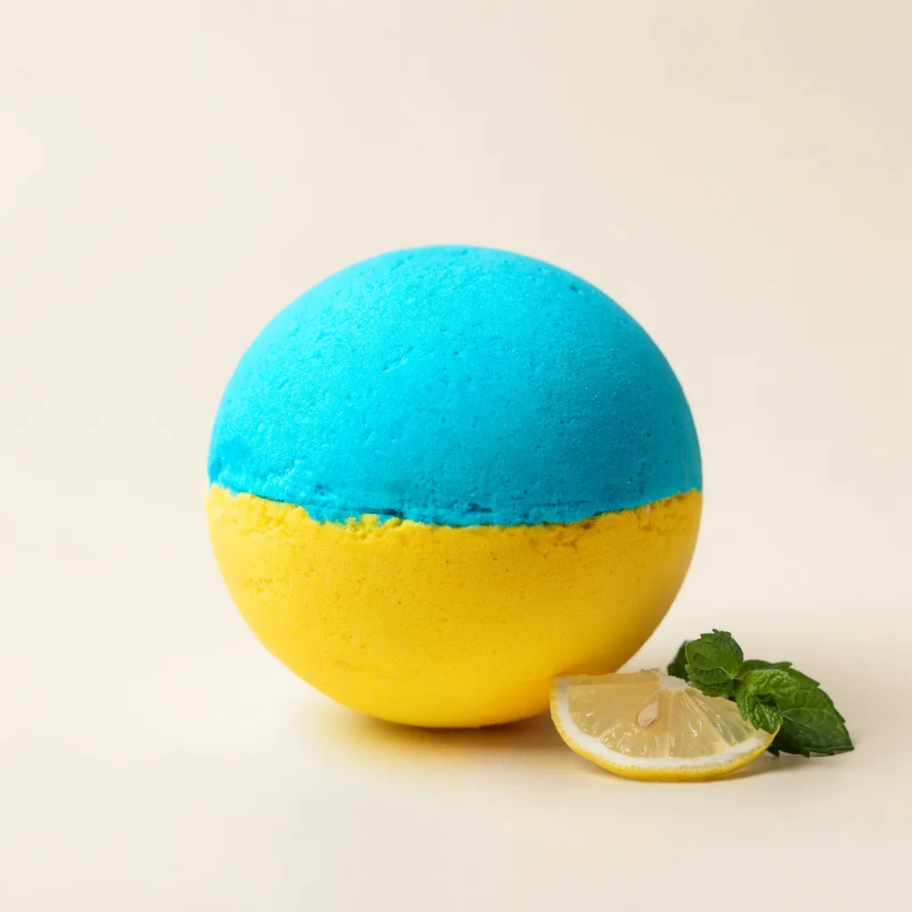 Minty Lemon Spark mugwort bath bomb, cyan top and lemon-yellow bottom