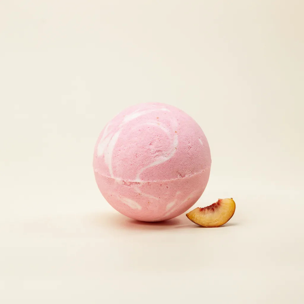 Creamy Peach Rush mugwort bath bomb, bright pink with white swirls